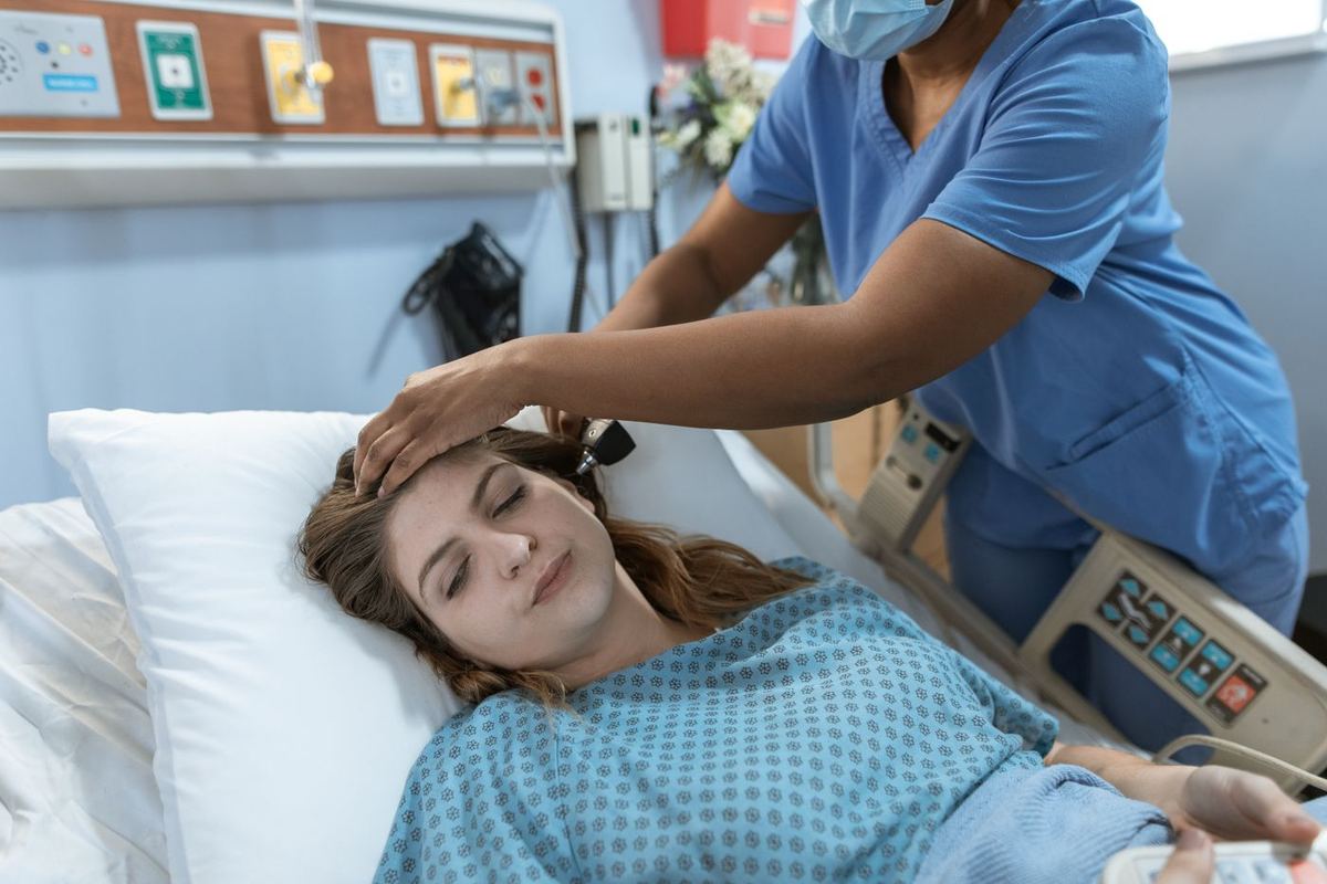 A nurse gently checking on a resident at the bedside