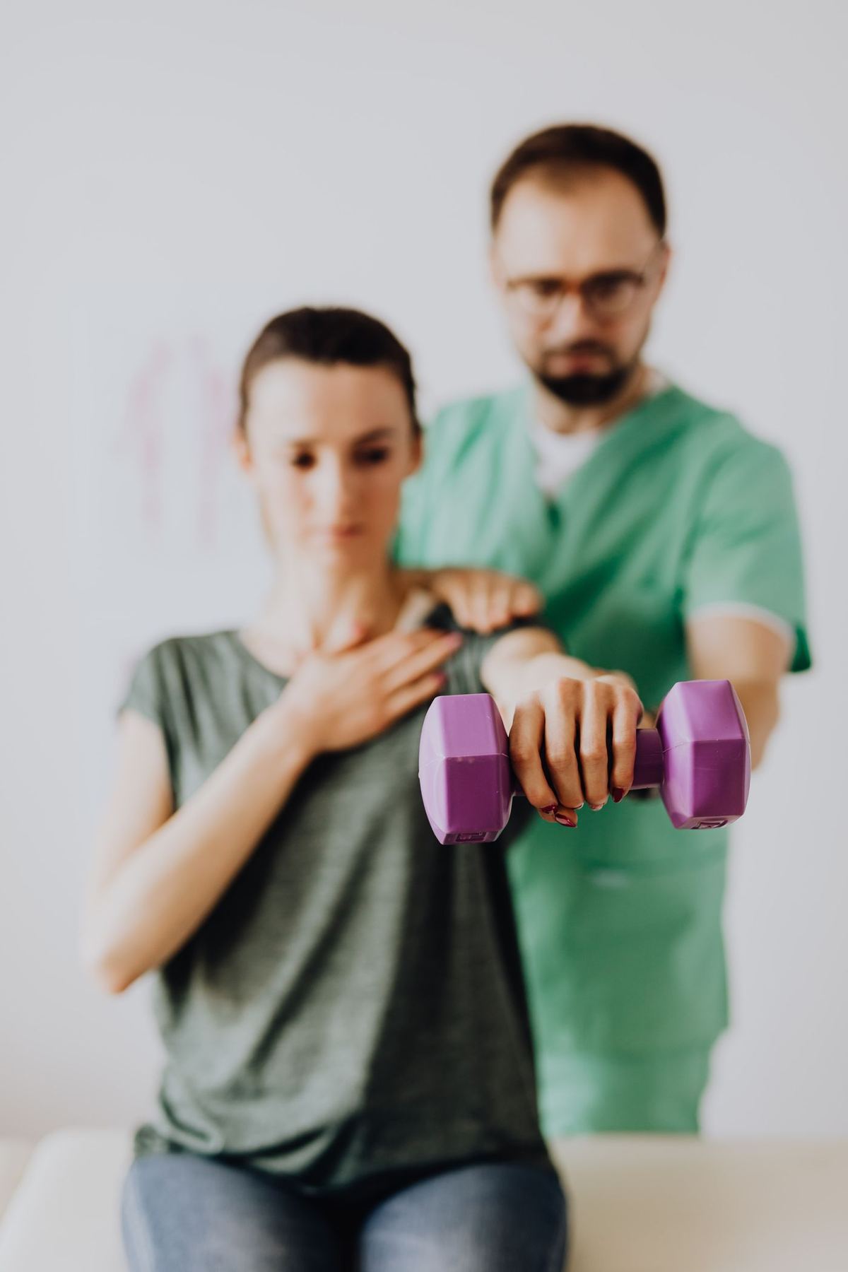 A therapist guiding a patient through strength exercises